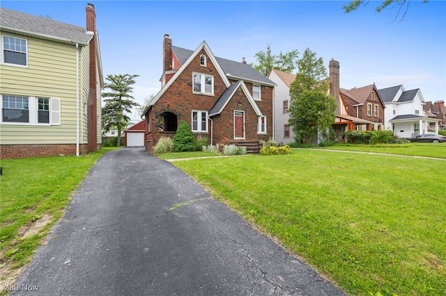 3497 Raymont Blvd, University Heights, OH 44118 - view of front of property with a front lawn, a residential view, an outdoor structure, and a detached garage