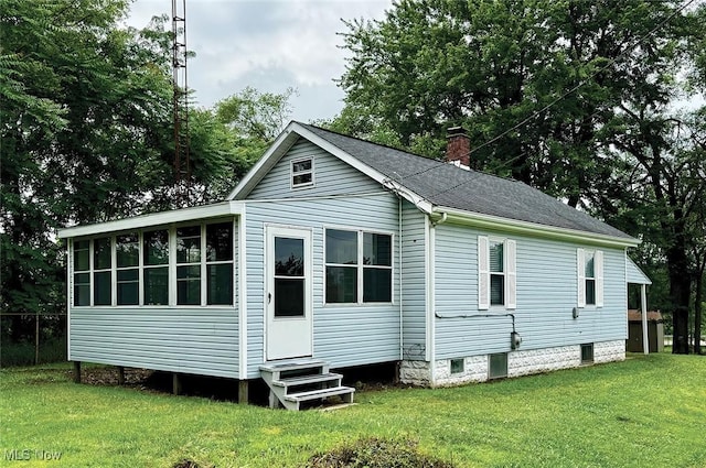 1729 Gambrinus Ave SW, Canton, OH 44706 - rear view of house featuring entry steps, a lawn, and a chimney