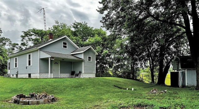 1729 Gambrinus Ave SW, Canton, OH 44706 - view of front of property with a chimney, a fire pit, and a shingled roof