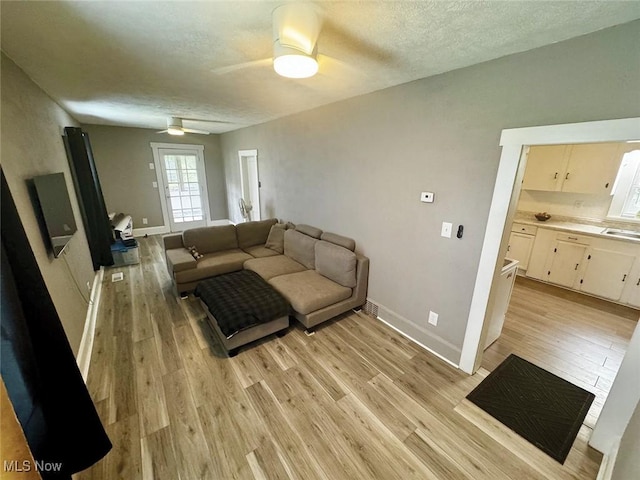 1729 Gambrinus Ave SW, Canton, OH 44706 - living area with a ceiling fan, light wood-style flooring, and a textured ceiling