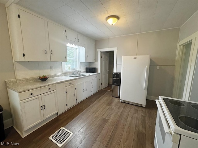 1729 Gambrinus Ave SW, Canton, OH 44706 - kitchen featuring white appliances, dark wood finished floors, light countertops, and white cabinetry