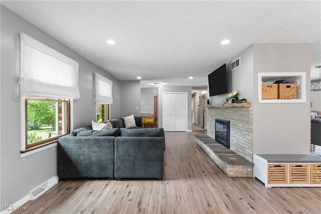3111 Serfass Rd, New Franklin, OH 44216 - living room with a brick fireplace, wood finished floors, and recessed lighting