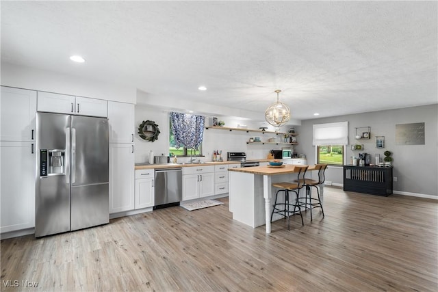 3111 Serfass Rd, New Franklin, OH 44216 - kitchen featuring stainless steel appliances, wood counters, white cabinetry, recessed lighting, and light wood finished floors