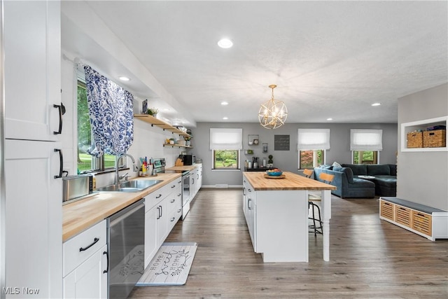 3111 Serfass Rd, New Franklin, OH 44216 - kitchen featuring wooden counters, stainless steel appliances, a breakfast bar area, white cabinetry, and recessed lighting
