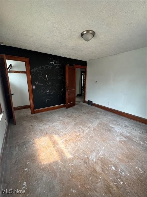 3038 E 130th St, Cleveland, OH 44120 - empty room featuring a textured ceiling and baseboards