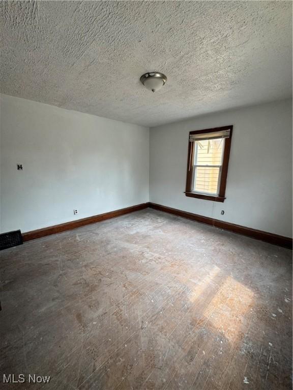 3038 E 130th St, Cleveland, OH 44120 - unfurnished room featuring a textured ceiling and wood finished floors