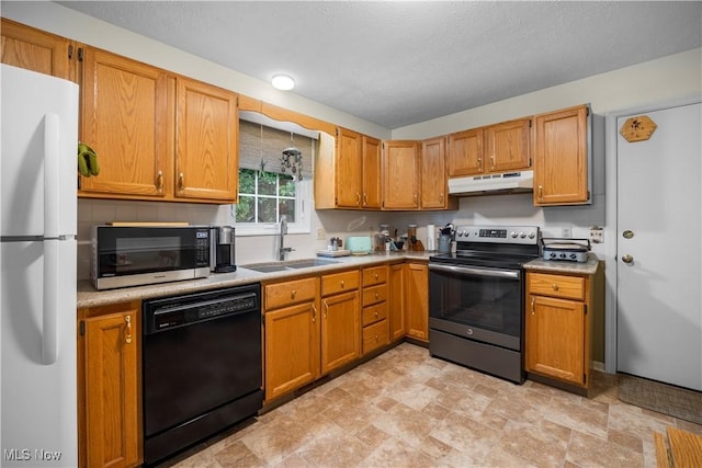 14531 Cross Creek Ln Unit 7, North Royalton, OH 44133 - kitchen with appliances with stainless steel finishes, under cabinet range hood, light countertops, and stone finish flooring