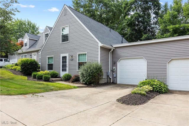 14531 Cross Creek Ln Unit 7, North Royalton, OH 44133 - view of front of house with driveway, an attached garage, and roof with shingles