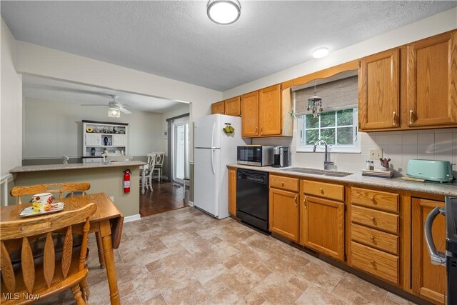 14531 Cross Creek Ln Unit 7, North Royalton, OH 44133 - kitchen with black dishwasher, stainless steel microwave, brown cabinetry, light countertops, and tasteful backsplash