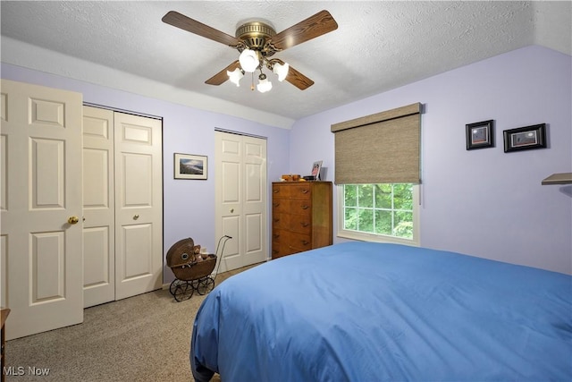 14531 Cross Creek Ln Unit 7, North Royalton, OH 44133 - bedroom featuring multiple closets, carpet floors, a ceiling fan, a textured ceiling, and vaulted ceiling