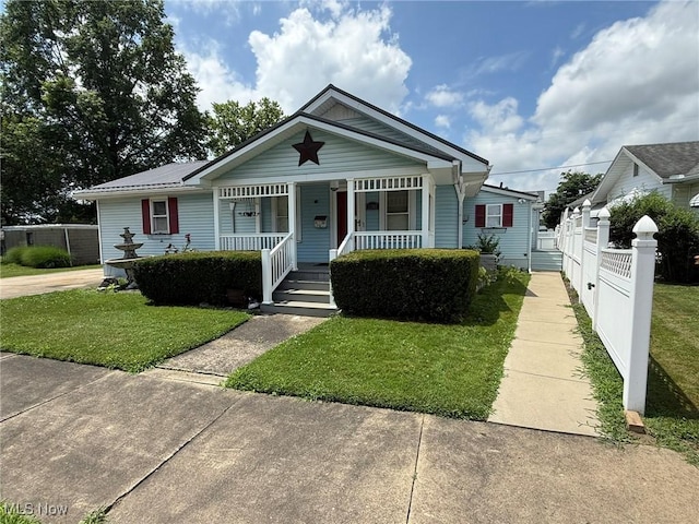 1208 3rd St NW, New Philadelphia, OH 44663 - bungalow featuring a porch
