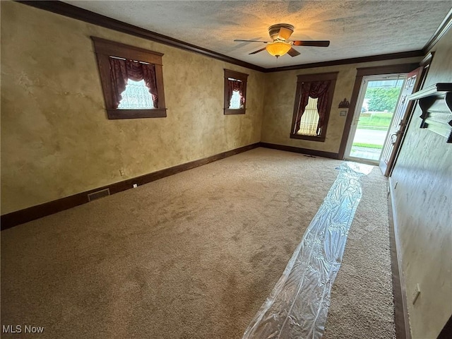 1208 3rd St NW, New Philadelphia, OH 44663 - spare room featuring crown molding, light colored carpet, a textured ceiling, and a ceiling fan