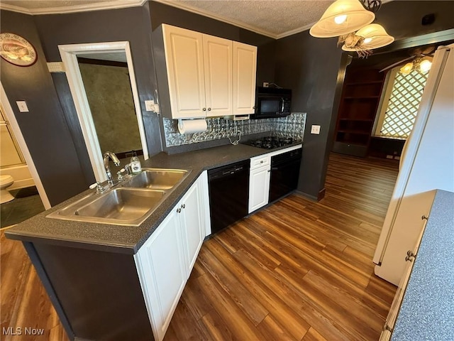 1208 3rd St NW, New Philadelphia, OH 44663 - kitchen featuring black appliances, dark countertops, white cabinets, and crown molding