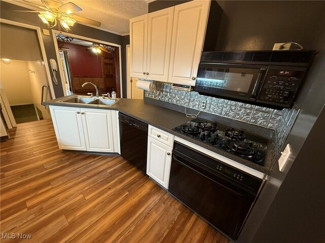 1208 3rd St NW, New Philadelphia, OH 44663 - kitchen featuring black appliances, dark countertops, white cabinets, ceiling fan, and a textured ceiling