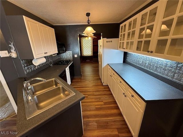 1208 3rd St NW, New Philadelphia, OH 44663 - kitchen featuring dark countertops, dark wood-style flooring, black appliances, tasteful backsplash, and ornamental molding