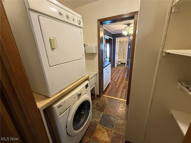 1208 3rd St NW, New Philadelphia, OH 44663 - washroom with stacked washer / dryer, dark stone finish flooring, and a ceiling fan