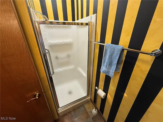 1208 3rd St NW, New Philadelphia, OH 44663 - bathroom featuring a shower stall and wallpapered walls