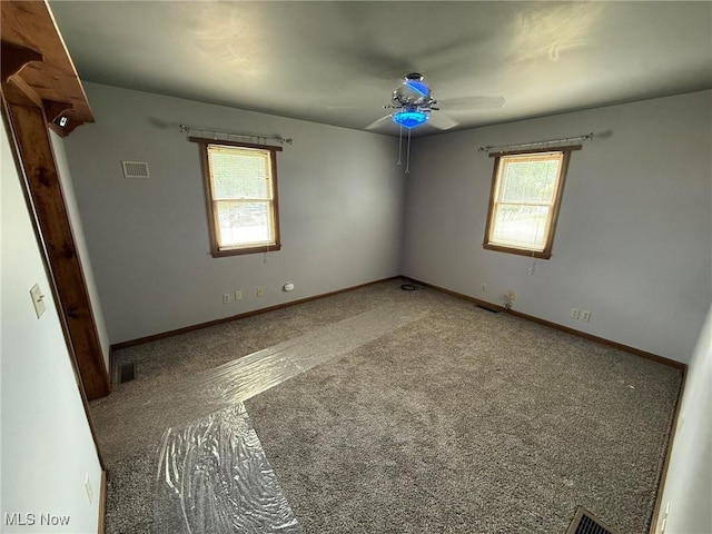 1208 3rd St NW, New Philadelphia, OH 44663 - empty room with ceiling fan and carpet flooring