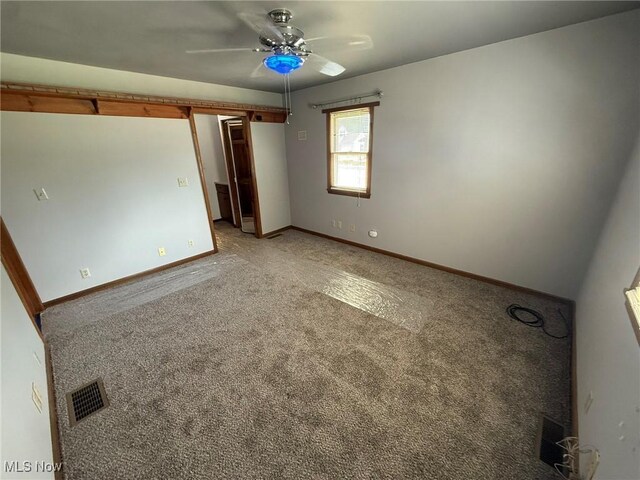 1208 3rd St NW, New Philadelphia, OH 44663 - unfurnished bedroom featuring light carpet and a ceiling fan