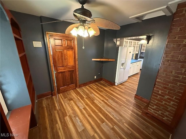 1208 3rd St NW, New Philadelphia, OH 44663 - unfurnished dining area with a ceiling fan and wood finished floors