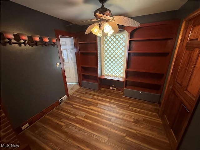 1208 3rd St NW, New Philadelphia, OH 44663 - unfurnished dining area featuring ceiling fan and dark wood-type flooring