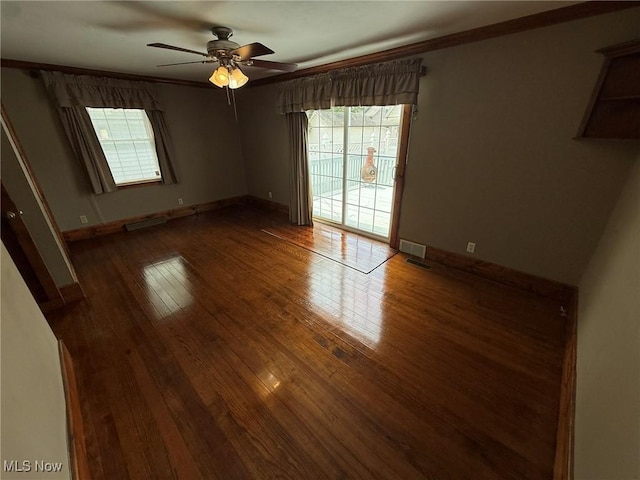 1208 3rd St NW, New Philadelphia, OH 44663 - unfurnished room featuring healthy amount of natural light, a ceiling fan, wood-type flooring, and ornamental molding