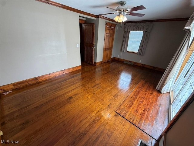 1208 3rd St NW, New Philadelphia, OH 44663 - empty room with wood-type flooring, crown molding, and ceiling fan