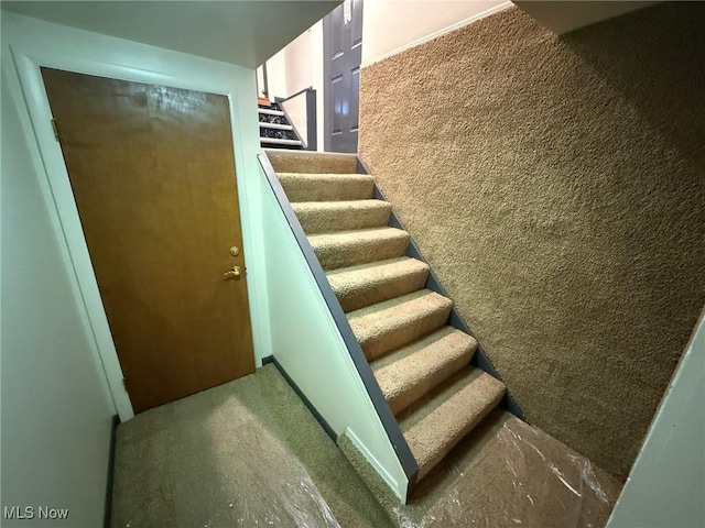 1208 3rd St NW, New Philadelphia, OH 44663 - stairway with carpet flooring