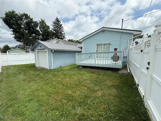 1208 3rd St NW, New Philadelphia, OH 44663 - rear view of house with a fenced backyard, a deck, an outbuilding, and a detached garage