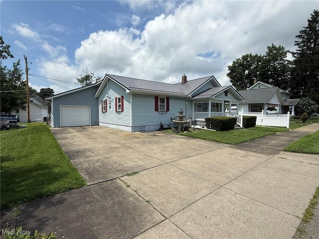 1208 3rd St NW, New Philadelphia, OH 44663 - view of front of property with concrete driveway, a front yard, a metal roof, covered porch, and an attached garage