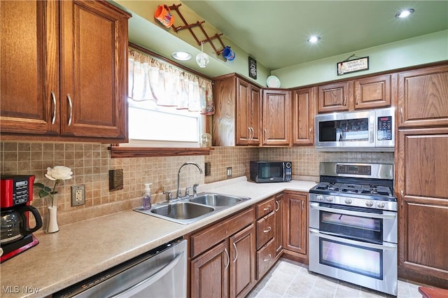 1433 Raleigh Blvd, Copley, OH 44321 - kitchen with stainless steel appliances, light countertops, tasteful backsplash, brown cabinets, and recessed lighting