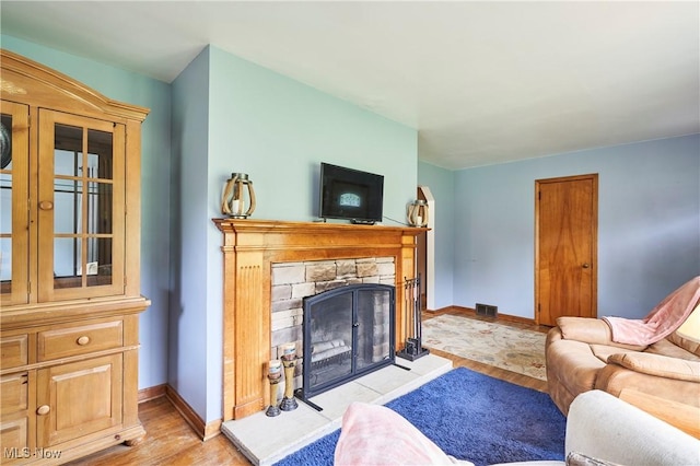 1433 Raleigh Blvd, Copley, OH 44321 - living room with light wood-style floors and a stone fireplace