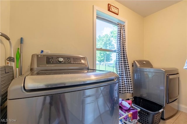 7716 N Ridge Pl, Lisbon, OH 44432 - washroom featuring washing machine and clothes dryer, healthy amount of natural light, and tile patterned floors
