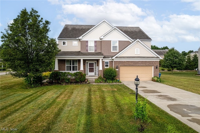 464 Marfa Cir, Copley, OH 44321 - craftsman house with covered porch, brick siding, concrete driveway, a front lawn, and a garage
