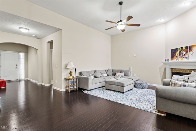 464 Marfa Cir, Copley, OH 44321 - living area featuring arched walkways, ceiling fan, a fireplace, and wood finished floors
