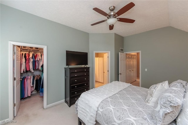 23450 Wainwright Ter, Olmsted Falls, OH 44138 - bedroom featuring lofted ceiling, light colored carpet, a walk in closet, a textured ceiling, and ceiling fan