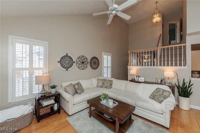 23450 Wainwright Ter, Olmsted Falls, OH 44138 - living area with healthy amount of natural light, wood finished floors, a ceiling fan, and high vaulted ceiling