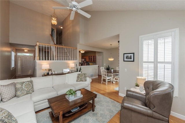 23450 Wainwright Ter, Olmsted Falls, OH 44138 - living area featuring high vaulted ceiling, wood finished floors, ceiling fan, and stairs