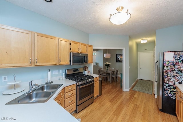 23450 Wainwright Ter, Olmsted Falls, OH 44138 - kitchen with appliances with stainless steel finishes, light brown cabinets, light countertops, light wood-style flooring, and a textured ceiling