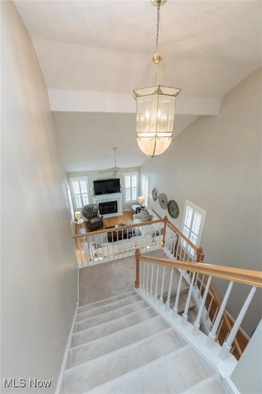 23450 Wainwright Ter, Olmsted Falls, OH 44138 - stairs with a chandelier and baseboards