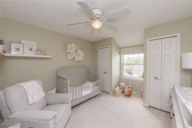 23450 Wainwright Ter, Olmsted Falls, OH 44138 - bedroom featuring multiple closets, light carpet, ceiling fan, and a crib
