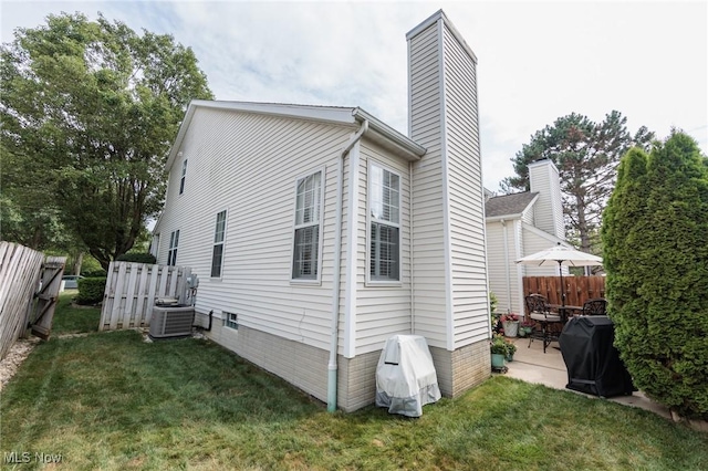 23450 Wainwright Ter, Olmsted Falls, OH 44138 - view of side of home with a chimney and a patio area