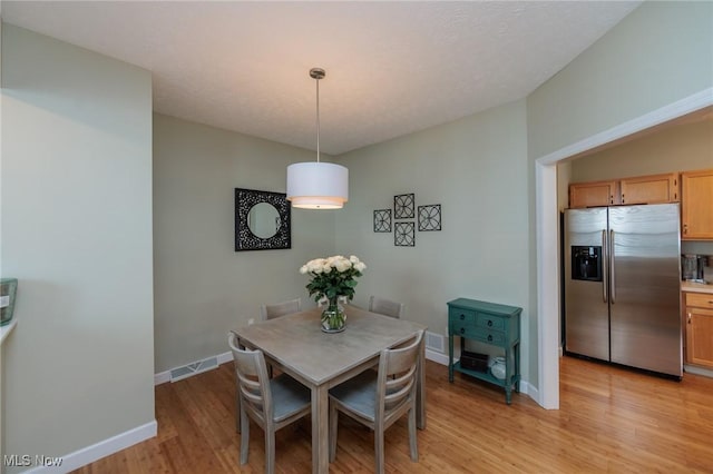 23450 Wainwright Ter, Olmsted Falls, OH 44138 - dining area featuring light wood-type flooring and baseboards