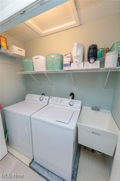 23450 Wainwright Ter, Olmsted Falls, OH 44138 - washroom featuring washer and clothes dryer and light tile patterned floors
