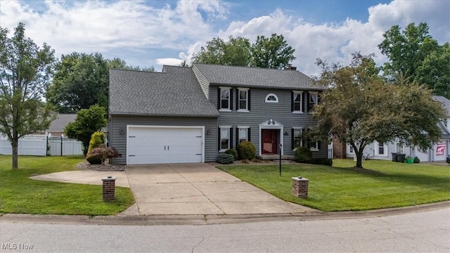 1103 Greenmont Cir, Vienna, WV 26105 - colonial house with an attached garage, concrete driveway, a shingled roof, and a chimney