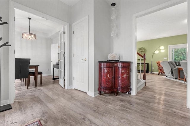 1103 Greenmont Cir, Vienna, WV 26105 - corridor featuring stairs, wood finished floors, and a chandelier