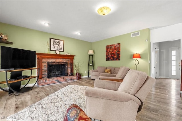 1103 Greenmont Cir, Vienna, WV 26105 - living room featuring wood finished floors and a brick fireplace