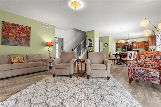 1103 Greenmont Cir, Vienna, WV 26105 - living room featuring light wood-style flooring and stairs