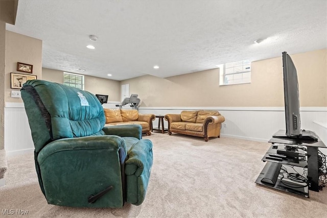 1103 Greenmont Cir, Vienna, WV 26105 - living area featuring carpet flooring, a textured ceiling, a wainscoted wall, and healthy amount of natural light