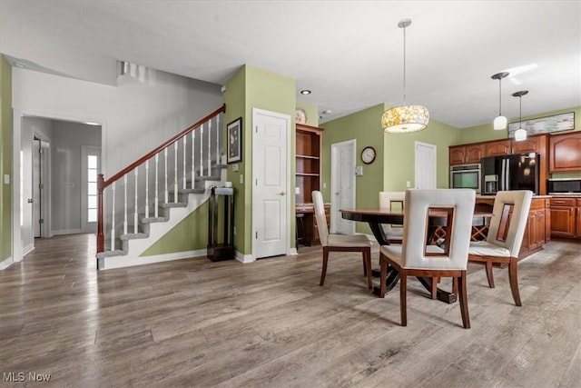 1103 Greenmont Cir, Vienna, WV 26105 - dining room with light wood-type flooring and stairs
